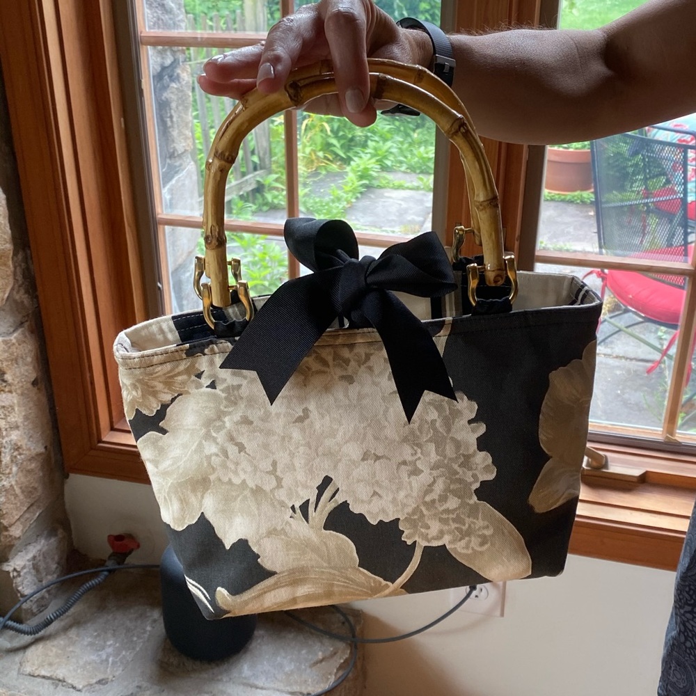 Darling fabric purse with bow closure.